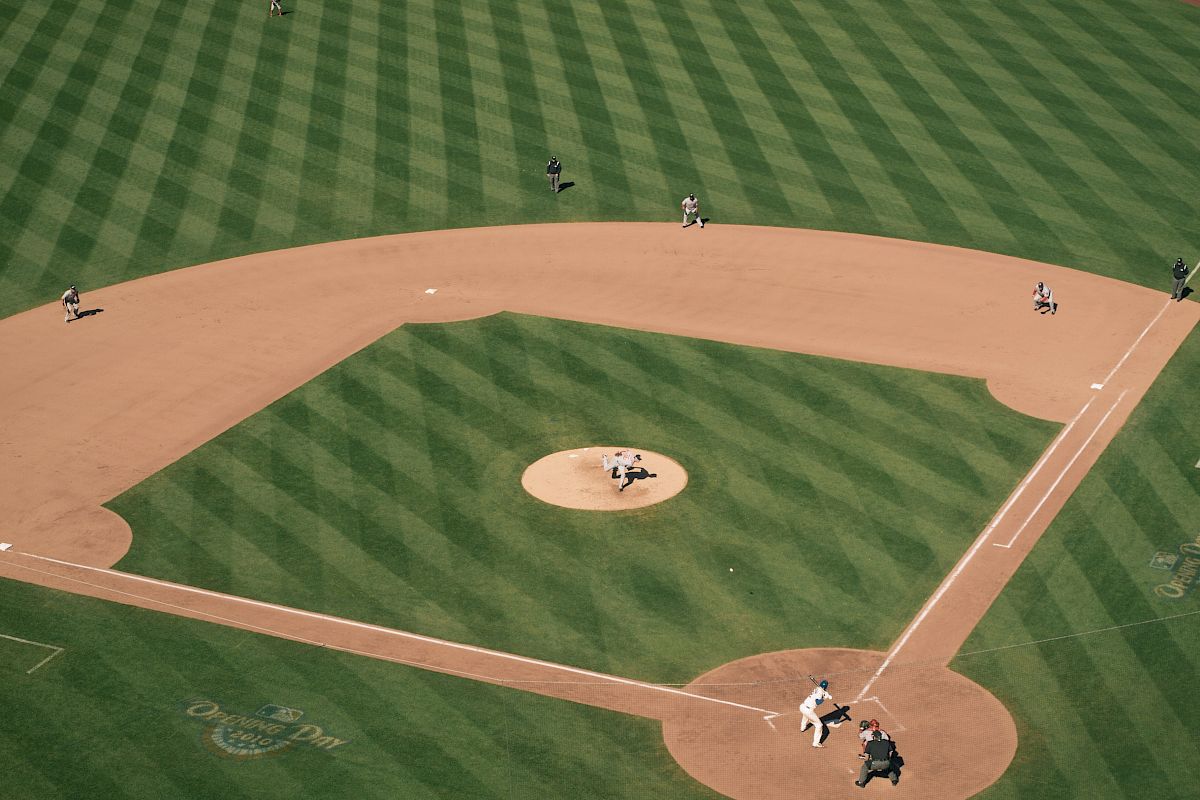 An aerial view of a baseball field during a game, with players positioned on the field and the batter at home plate.