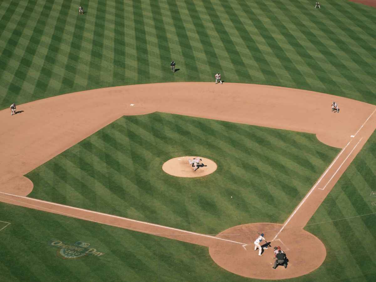 An aerial view of a baseball field during a game, with players positioned on the field and the batter at home plate.