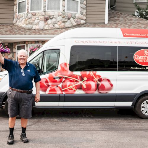 School bus on street with kids&rsquo; drawings on side, urban storefronts, and a person near the bus.