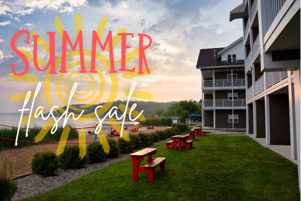 The image shows a seaside scene with a building and "Summer Flash Sale" text overlaid in bright colors.